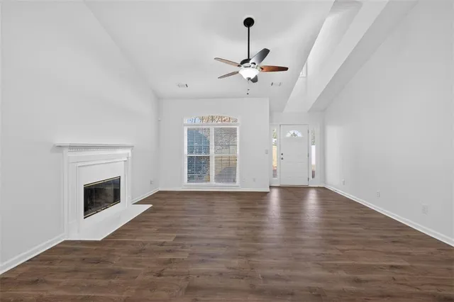 a view of an empty room with exposed radiator and fireplace
