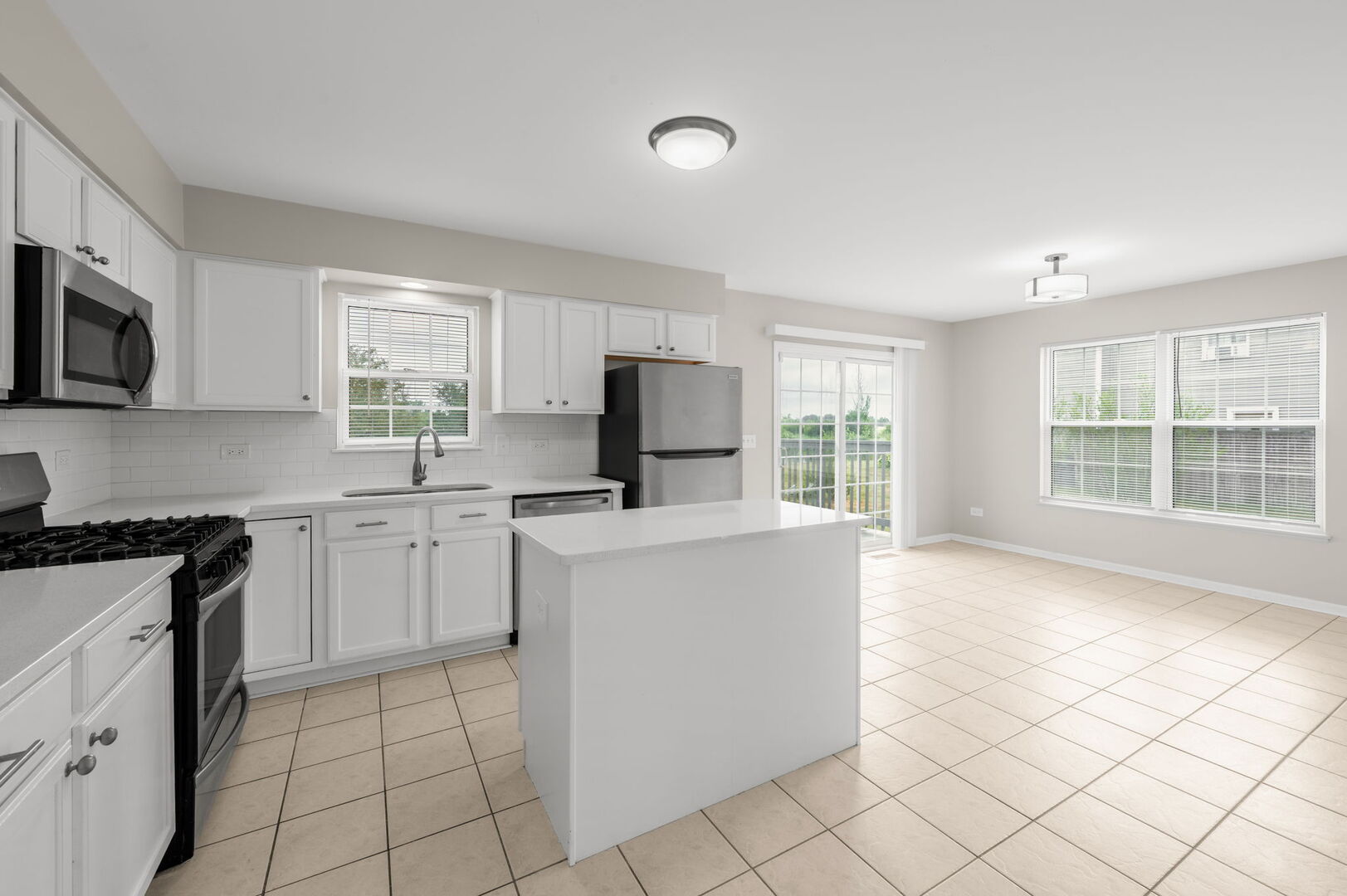 4508 Azalea Avenue Monee, IL 60449 - Photo 9 of 26 a kitchen with a stove a sink and a microwave