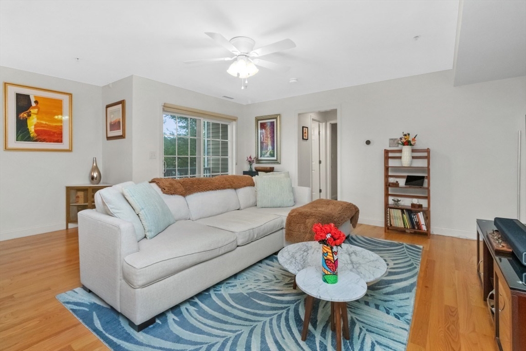 29 Spruce Street, Unit 23 Waltham, MA 02453 - Photo 8 of 26 a living room with furniture and wooden floor