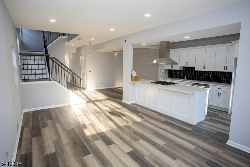 267 Perry Avenue Union, NJ 07083 - Photo 11 of 46 a large kitchen with stainless steel appliances kitchen island granite countertop a sink and a stove