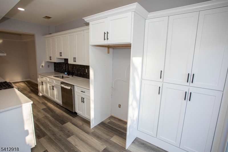 267 Perry Avenue Union, NJ 07083 - Photo 13 of 46 a kitchen with stainless steel appliances white cabinets and a sink