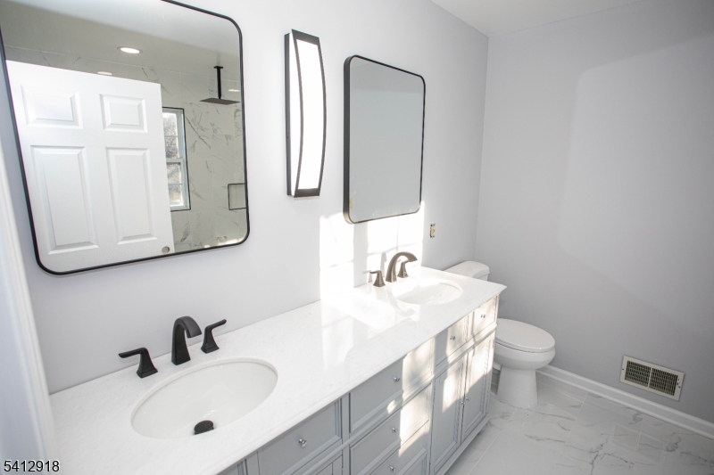 267 Perry Avenue Union, NJ 07083 - Photo 25 of 46 a bathroom with double vanity sink and a mirror