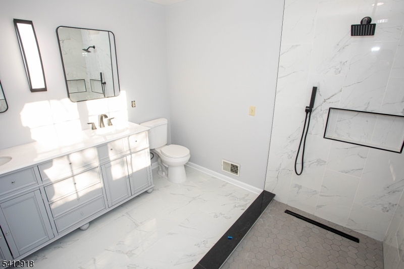 267 Perry Avenue Union, NJ 07083 - Photo 27 of 46 a bathroom with a sink toilet and mirror