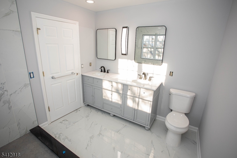 267 Perry Avenue Union, NJ 07083 - Photo 29 of 46 a bathroom with a toilet sink and mirror