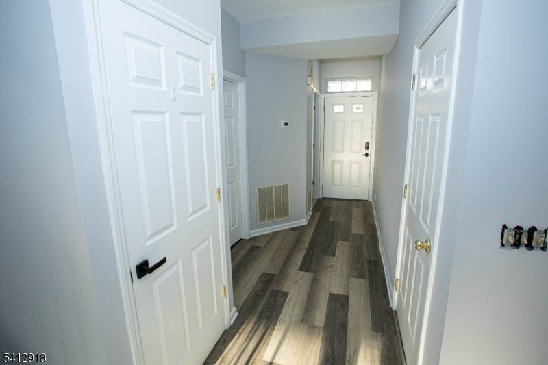 267 Perry Avenue Union, NJ 07083 - Photo 3 of 46 a view of a hallway with wooden floor and a bathroom