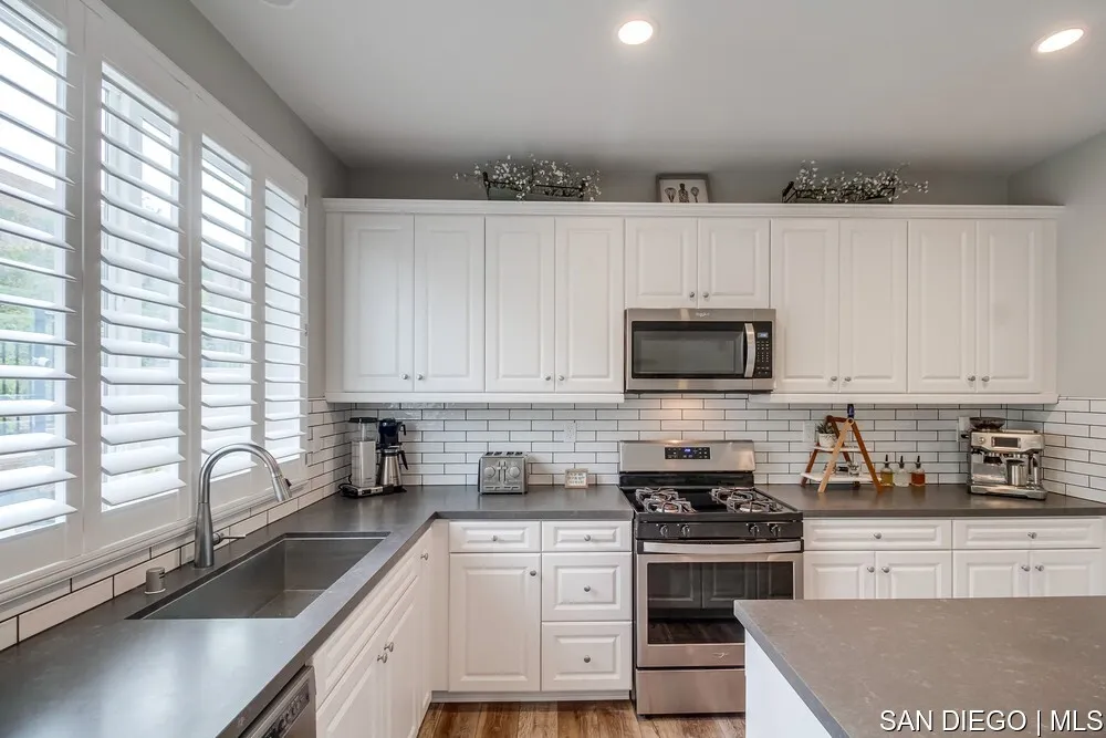 8532 Boulder Way Santee, CA 92071 - Photo 11 of 54 a kitchen with granite countertop a sink stainless steel appliances and cabinets