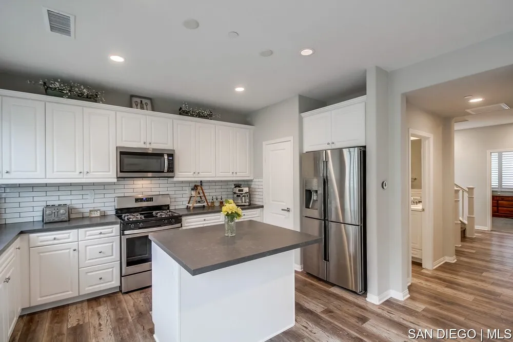 8532 Boulder Way Santee, CA 92071 - Photo 12 of 54 a kitchen with a refrigerator a sink and a stove top oven