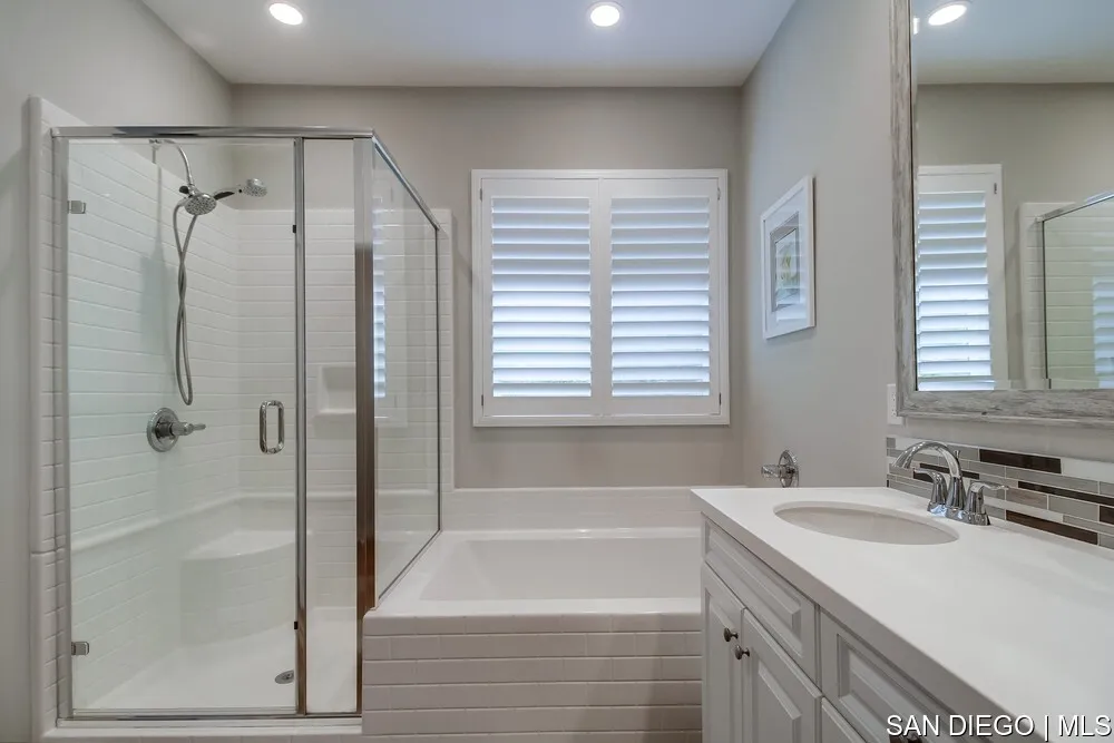 8532 Boulder Way Santee, CA 92071 - Photo 42 of 54 a bathroom with a granite countertop sink a mirror and a bathtub