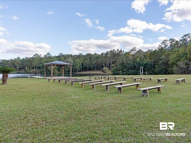 4650 Wiggins Lane Wilmer, AL 36587 - Photo 33 of 66 View of community with a lawn, a gazebo, and a view of trees