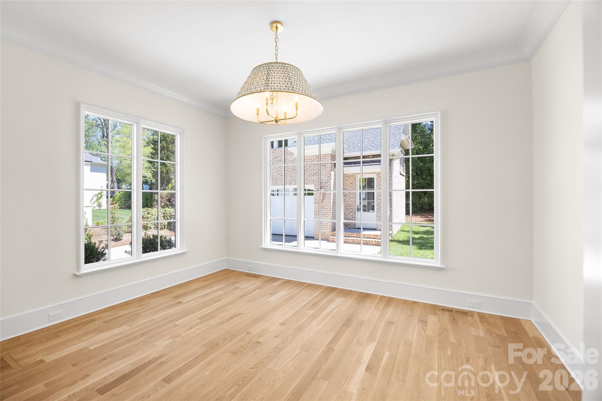 1615 Coventry Road Charlotte, NC 28211 - Photo 19 of 48 a view of an empty room with wooden floor and a window