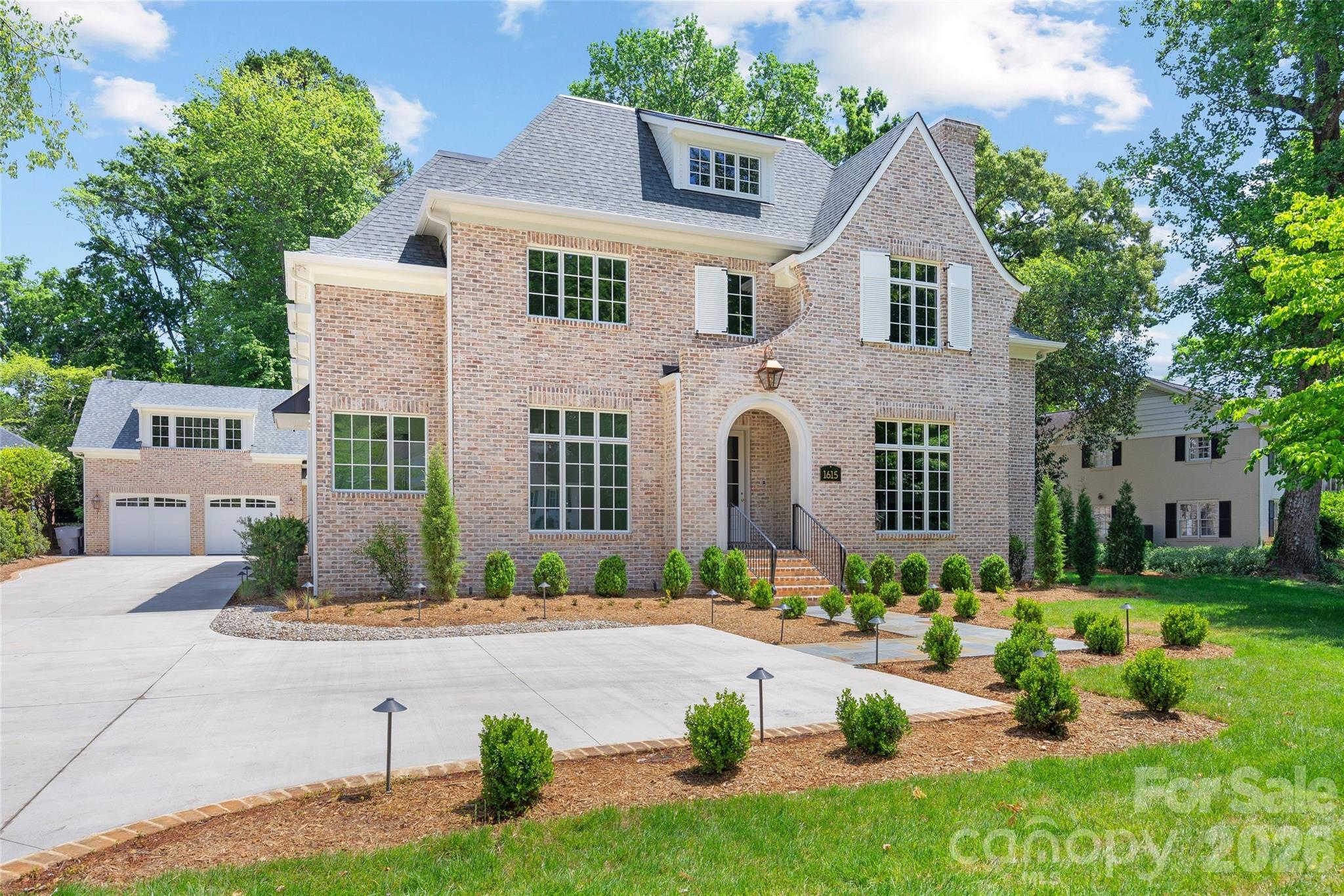 1615 Coventry Road Charlotte, NC 28211 - Photo 2 of 48 a front view of a house with garden and patio