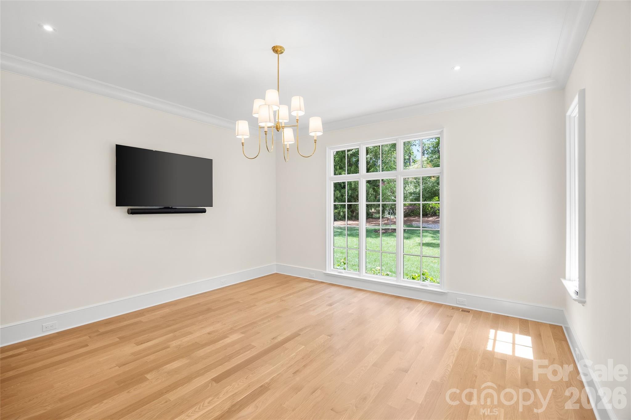 1615 Coventry Road Charlotte, NC 28211 - Photo 24 of 48 a view of an empty room with wooden floor and a window