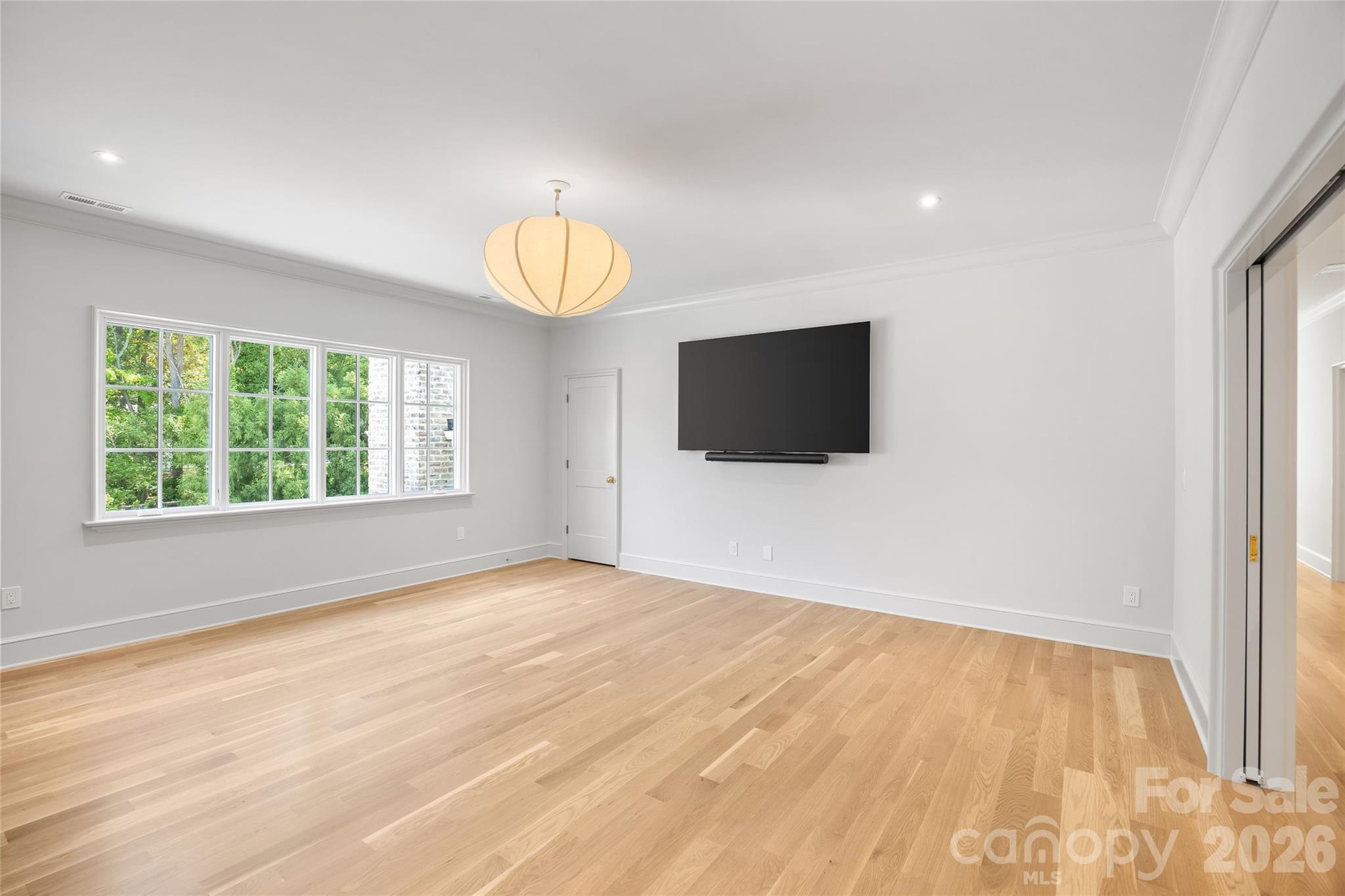 1615 Coventry Road Charlotte, NC 28211 - Photo 28 of 48 a view of an empty room with wooden floor and a window