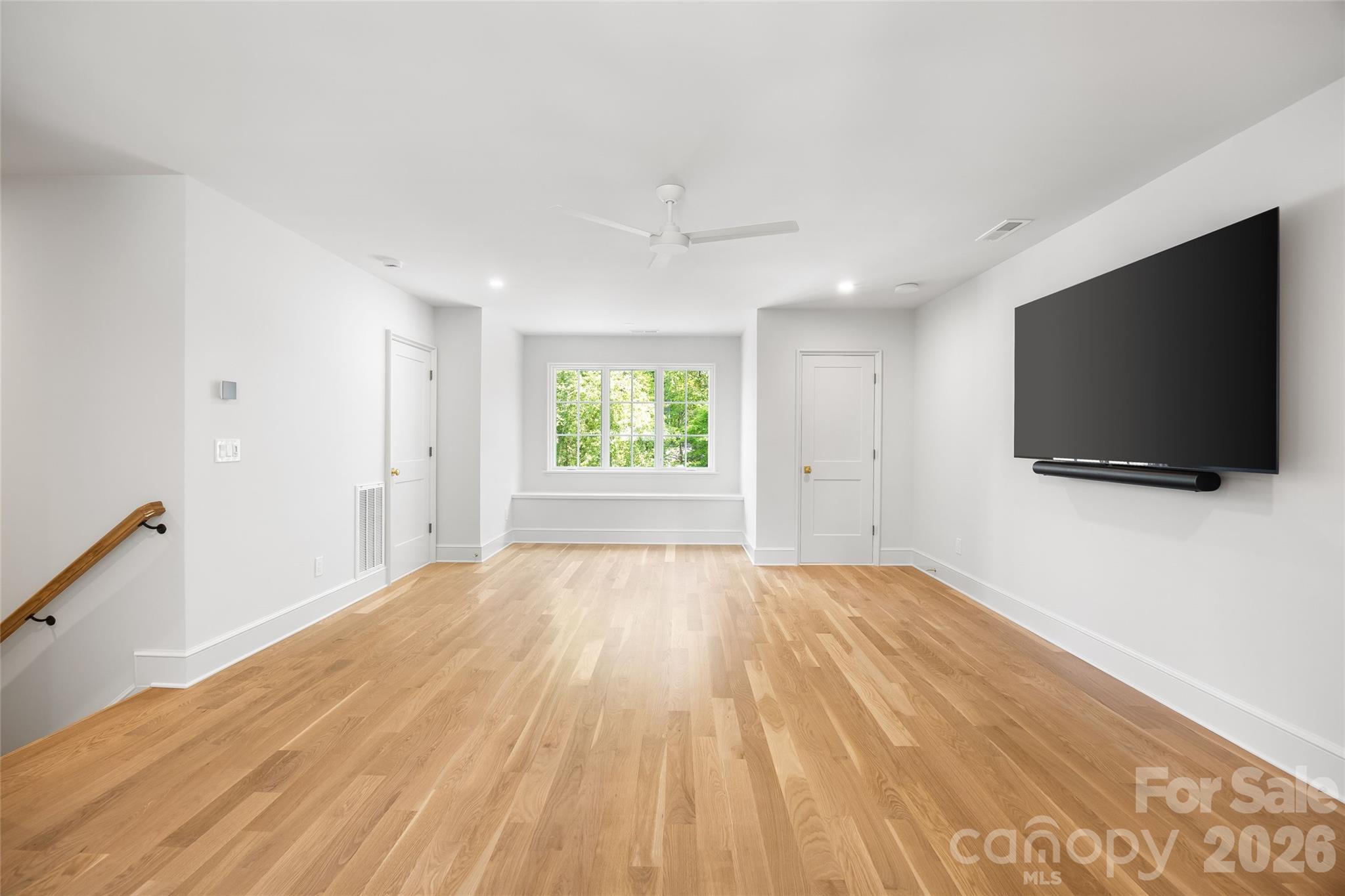 1615 Coventry Road Charlotte, NC 28211 - Photo 40 of 48 a view of a livingroom with a flat screen tv wooden floor and window