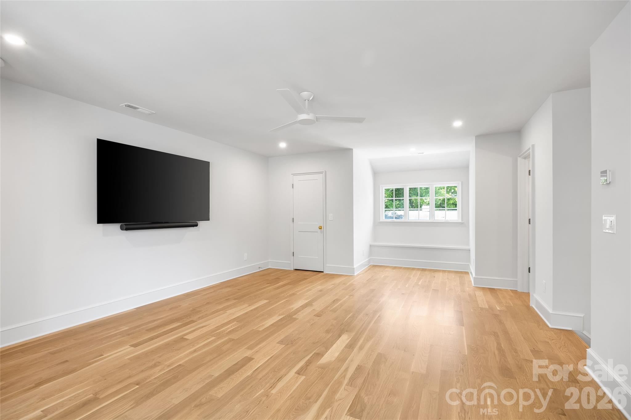 1615 Coventry Road Charlotte, NC 28211 - Photo 41 of 48 a view of an empty room with wooden floor and a window