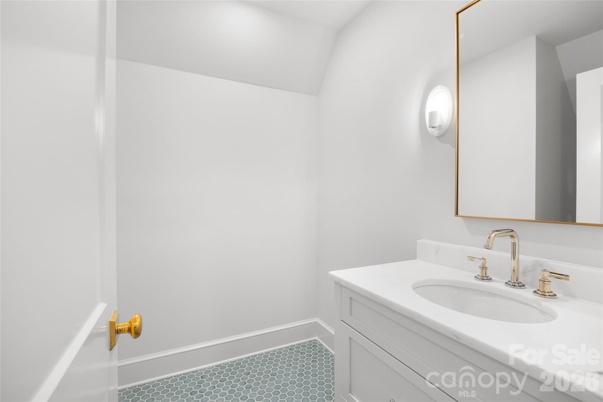 1615 Coventry Road Charlotte, NC 28211 - Photo 42 of 48 a bathroom with a sink and a mirror