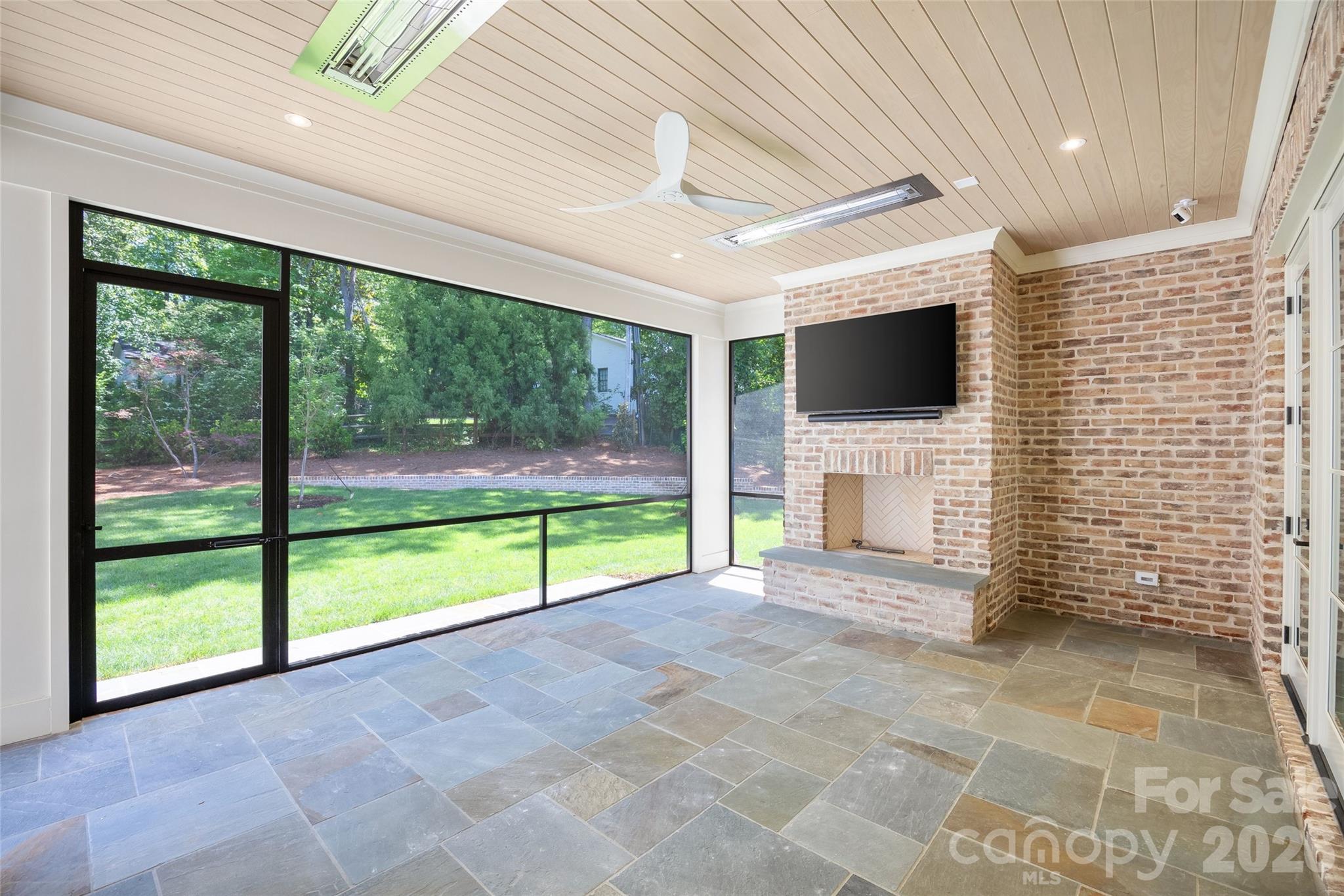 1615 Coventry Road Charlotte, NC 28211 - Photo 46 of 48 a view of an empty room with a fireplace and a flat tv screen