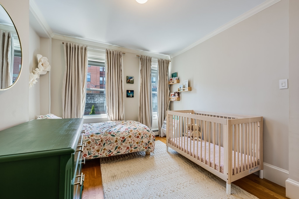 39 Emerson Street Boston, MA 02127 - Photo 14 of 20 a bedroom with a bed and wooden floor