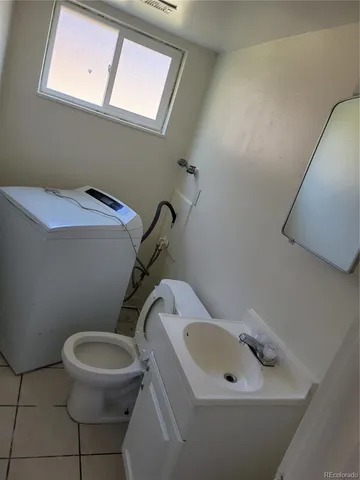a bathroom with a sink mirror and toilet