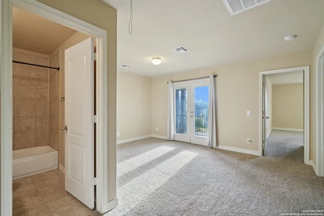 an empty room with closet and mirror