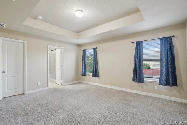 a bathroom with a granite countertop sink a toilet and a large mirror