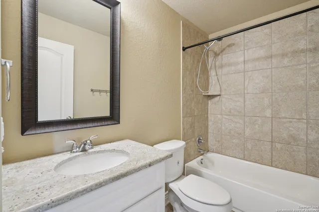 a view of backyard with wooden fence