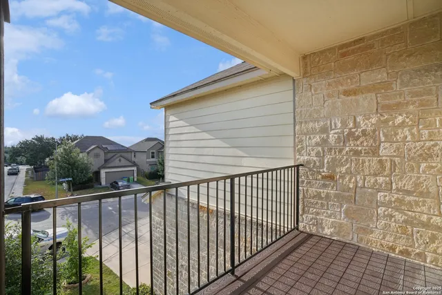 a view of a balcony with wooden fence