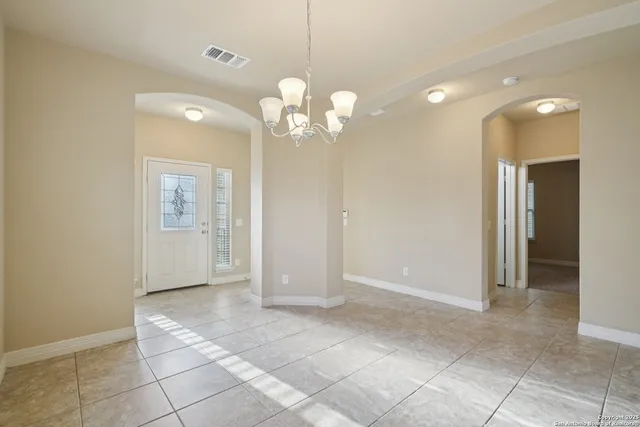 a view of a hallway with chandelier