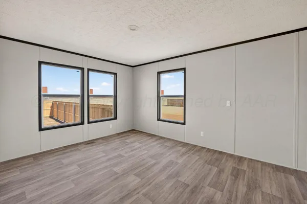an empty room with windows and closet