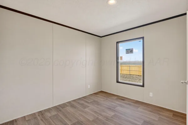 an empty room with windows and closet