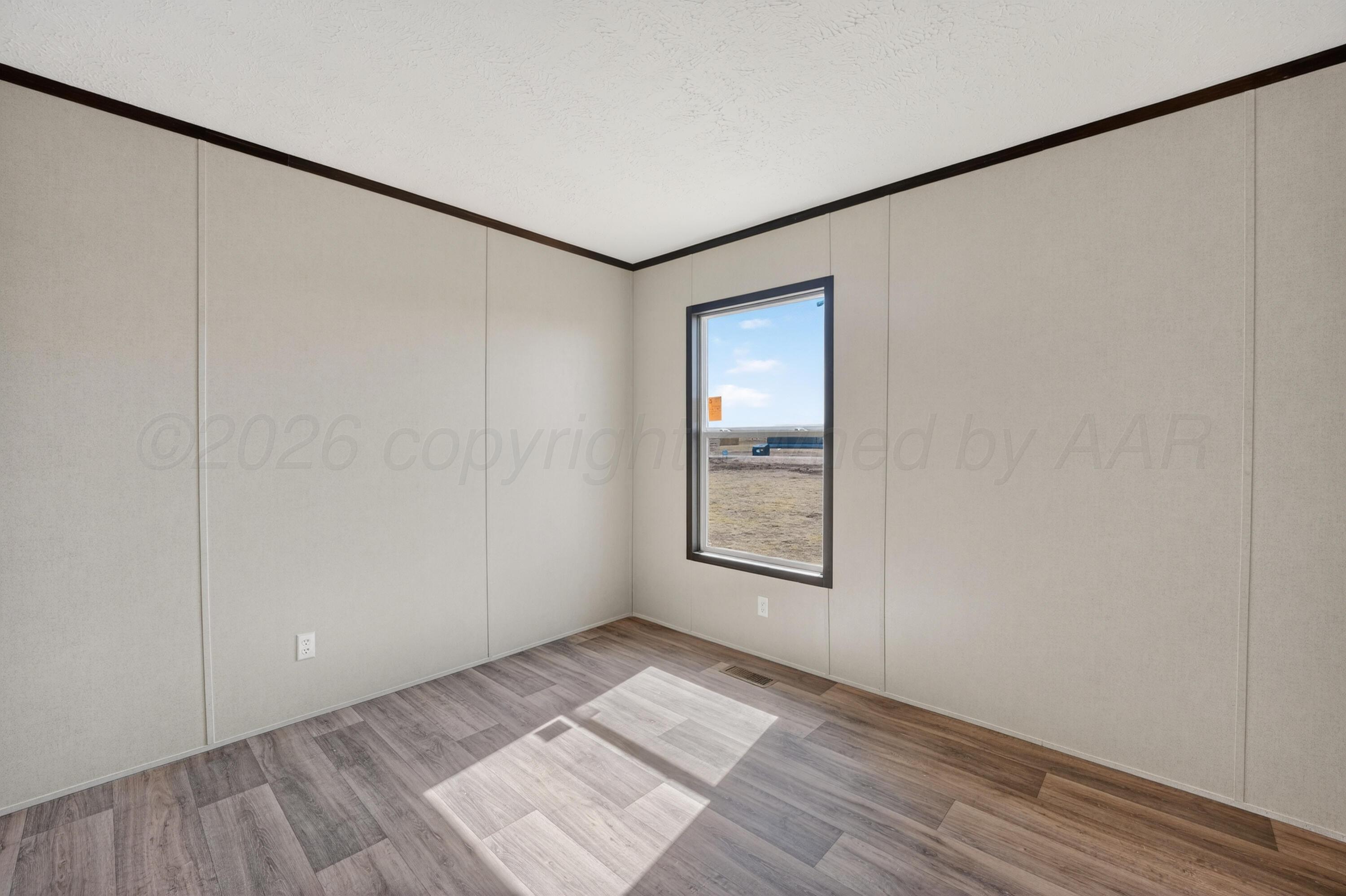 2721 Avery Rd Canyon Canyon, TX 79015 - Photo 14 of 30 a view of an empty room with wooden floor and a window