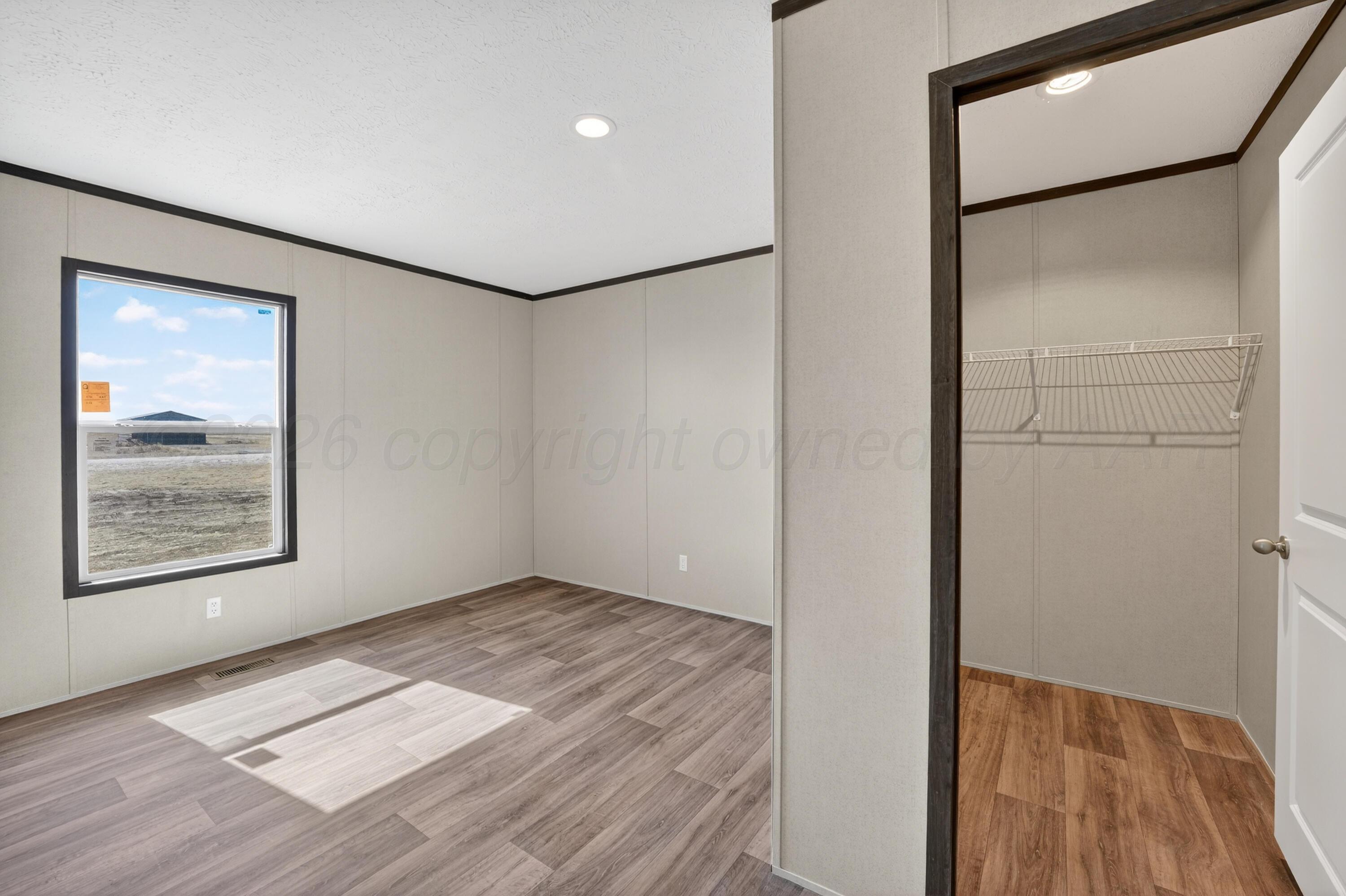 2721 Avery Rd Canyon Canyon, TX 79015 - Photo 15 of 30 a view of an empty room with wooden floor and a window