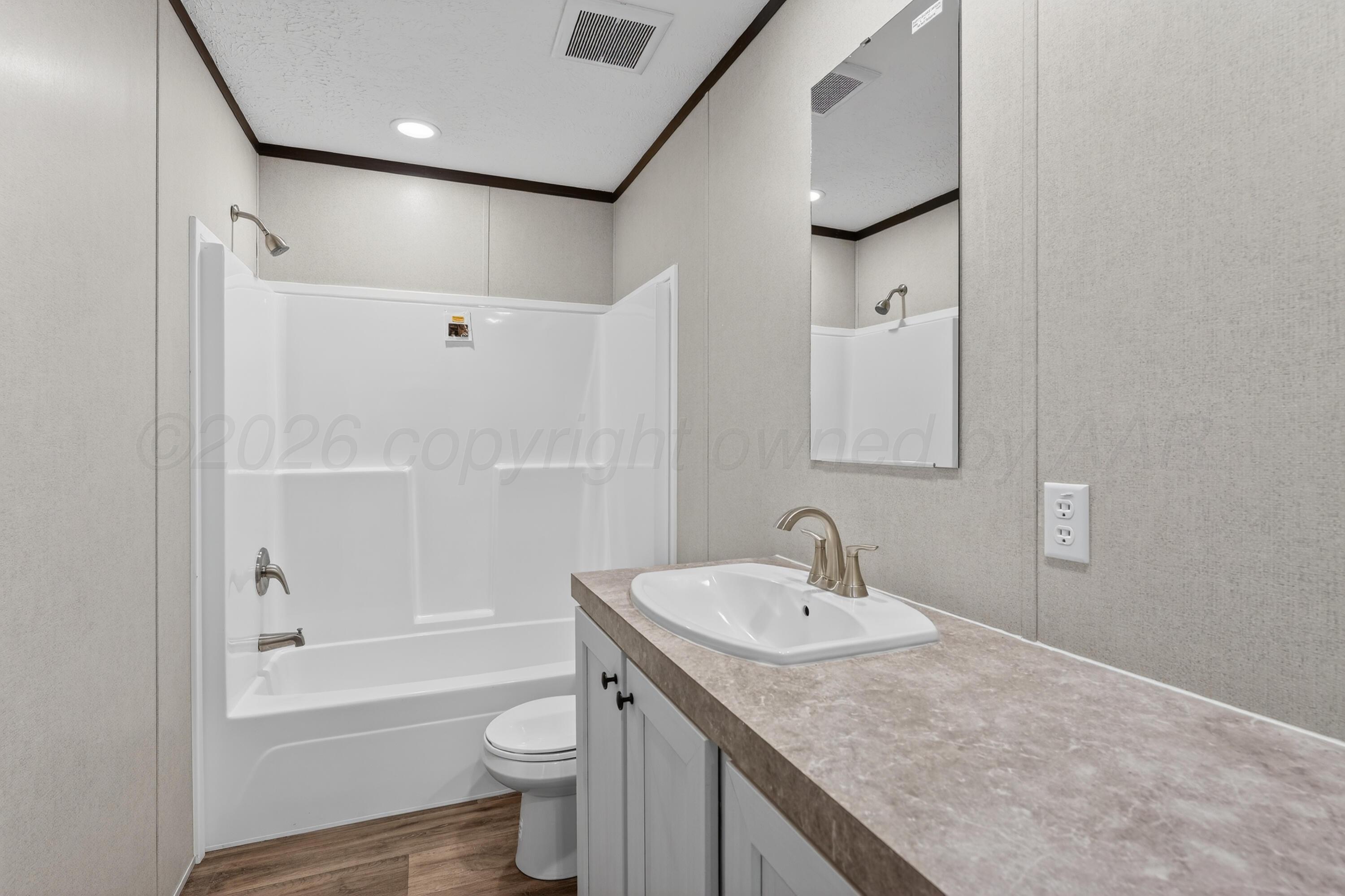 2721 Avery Rd Canyon Canyon, TX 79015 - Photo 16 of 30 a bathroom with a granite countertop sink toilet and shower