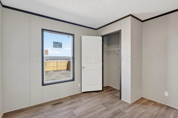 a view of a room with wooden floor and a shower