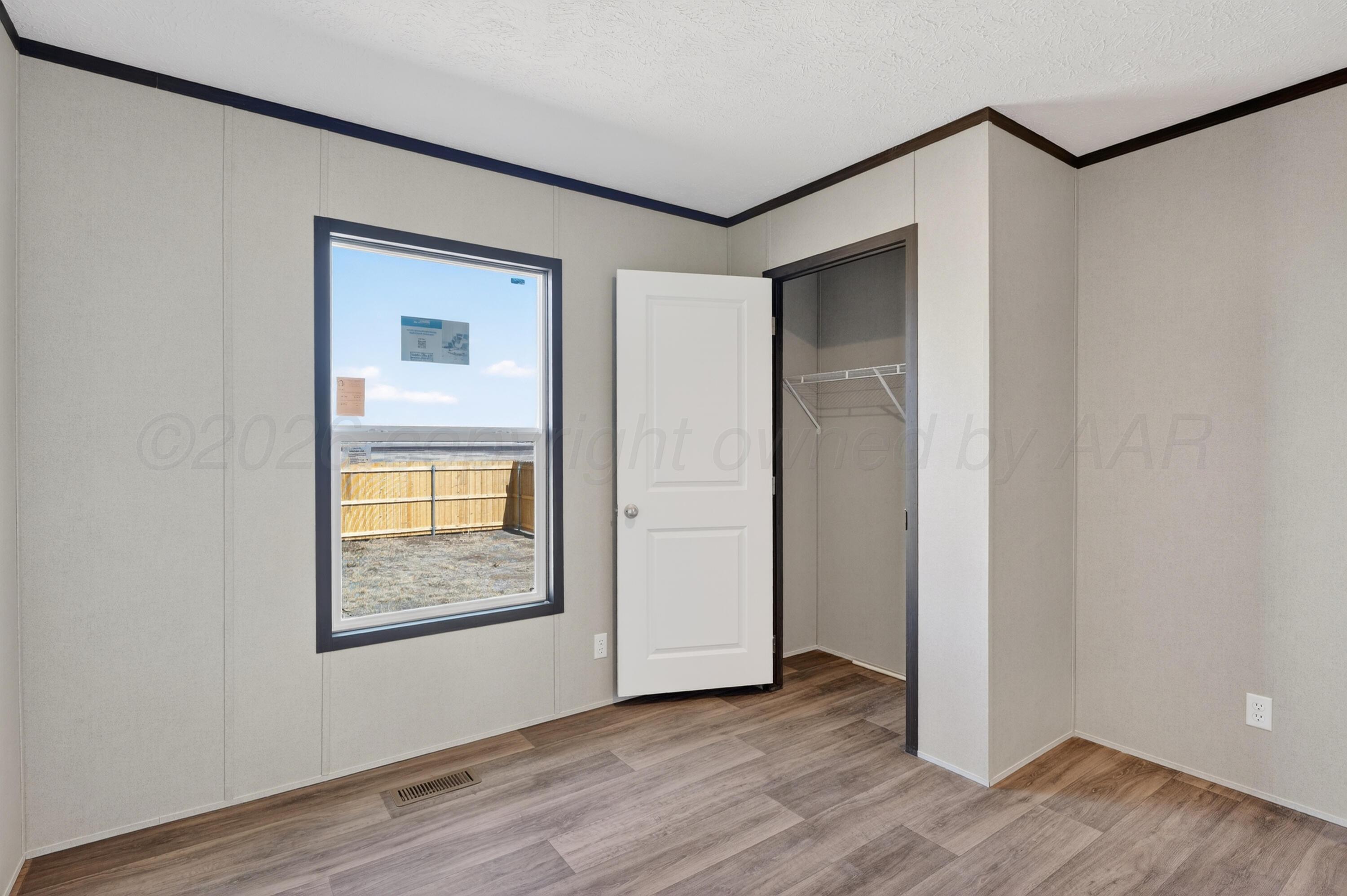 2721 Avery Rd Canyon Canyon, TX 79015 - Photo 18 of 30 an empty room with wooden floor and a window