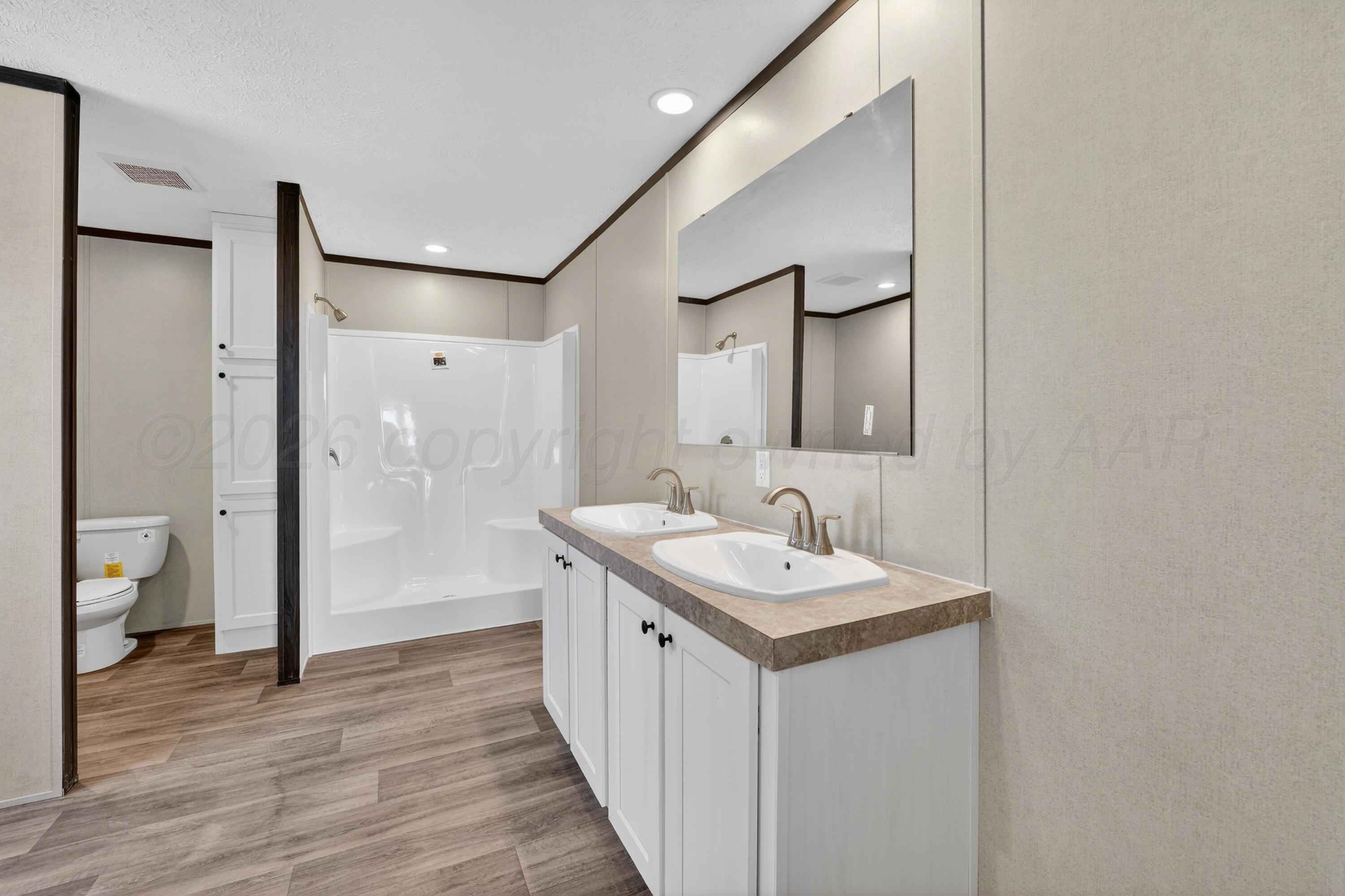 2721 Avery Rd Canyon Canyon, TX 79015 - Photo 21 of 30 a bathroom with a sink a toilet and shower