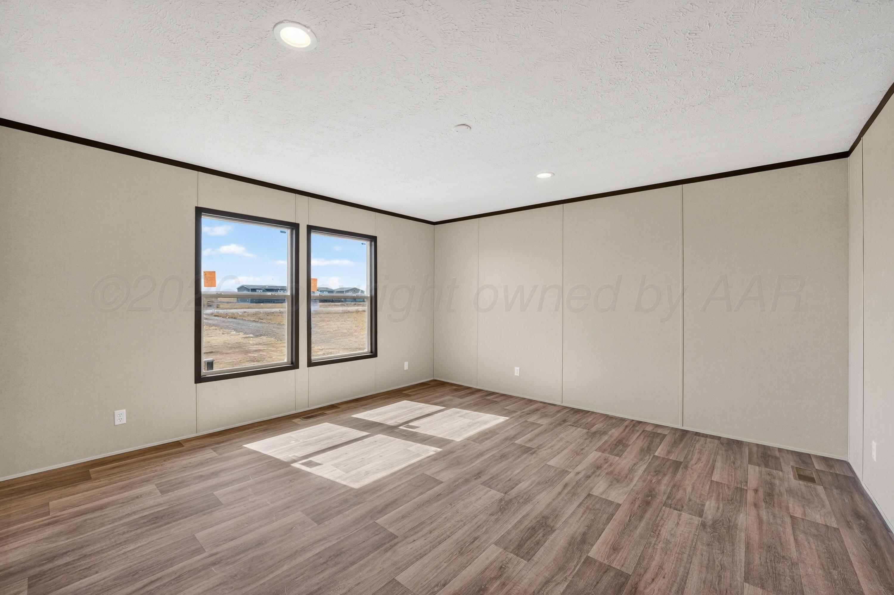 2721 Avery Rd Canyon Canyon, TX 79015 - Photo 25 of 30 an empty room with wooden floor and windows