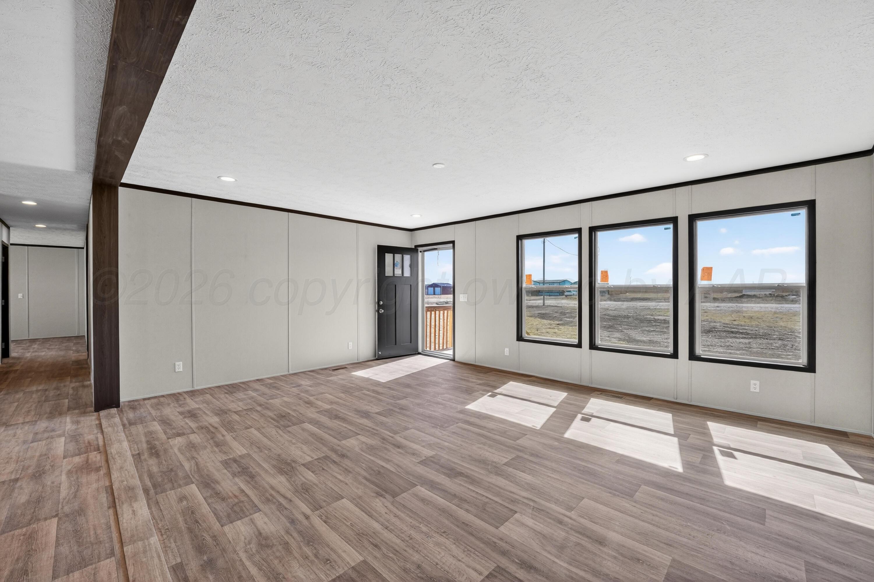 2721 Avery Rd Canyon Canyon, TX 79015 - Photo 5 of 30 a view of an empty room with a window and wooden floor