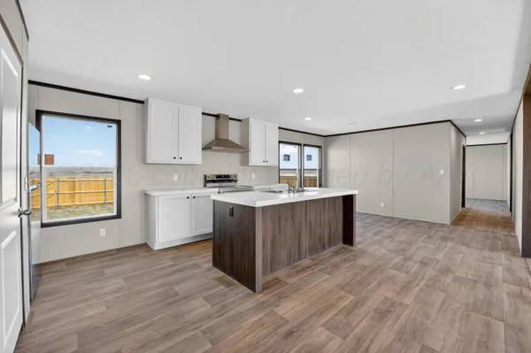 a kitchen with wooden floors and cabinets