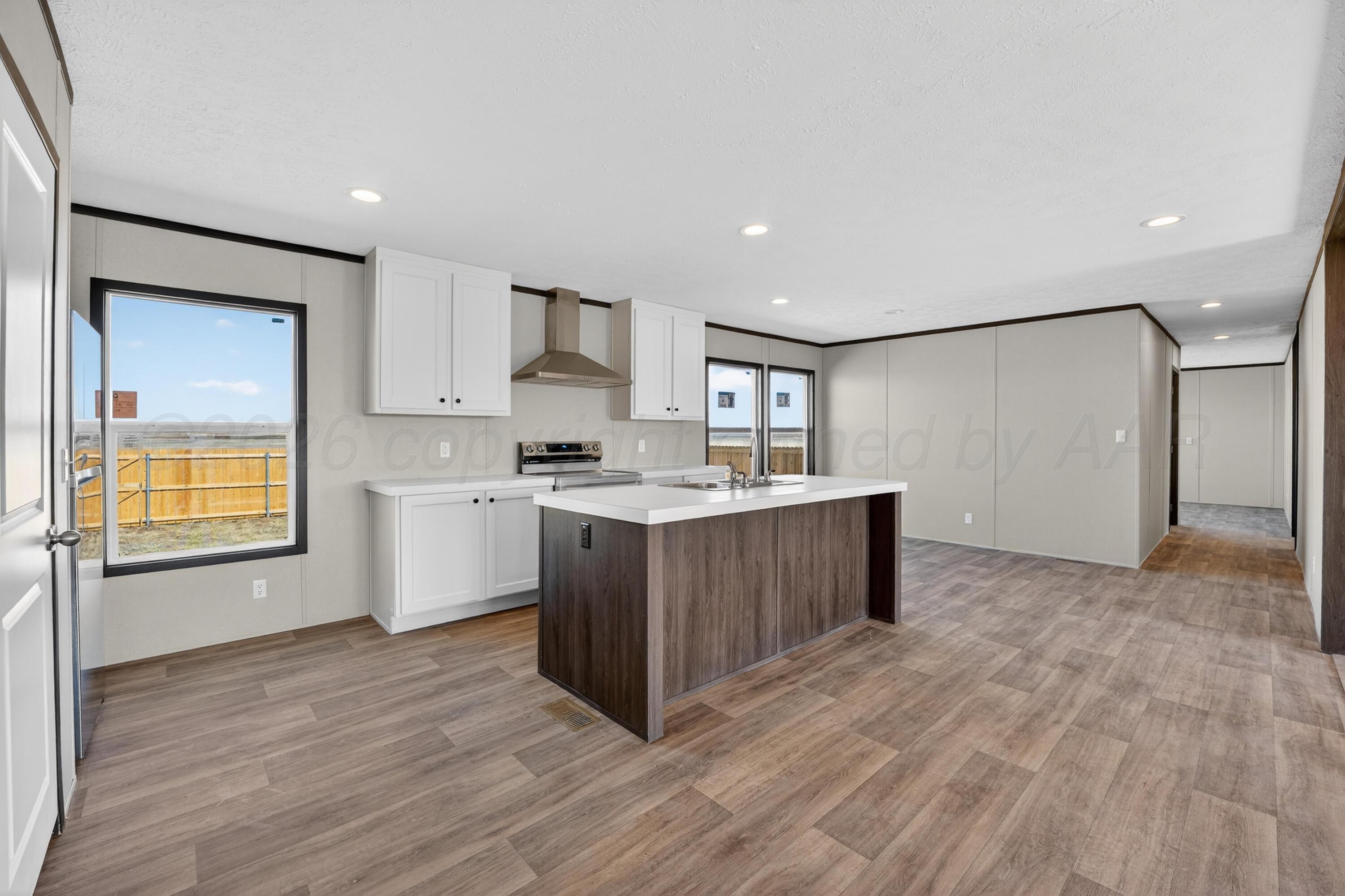 2721 Avery Rd Canyon Canyon, TX 79015 - Photo 6 of 30 a kitchen with wooden floors and cabinets