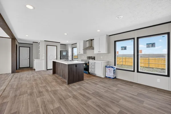 a view of a kitchen with wooden floor and a sink