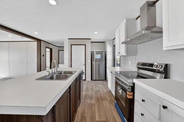 a kitchen with stainless steel appliances granite countertop a sink and stove top oven