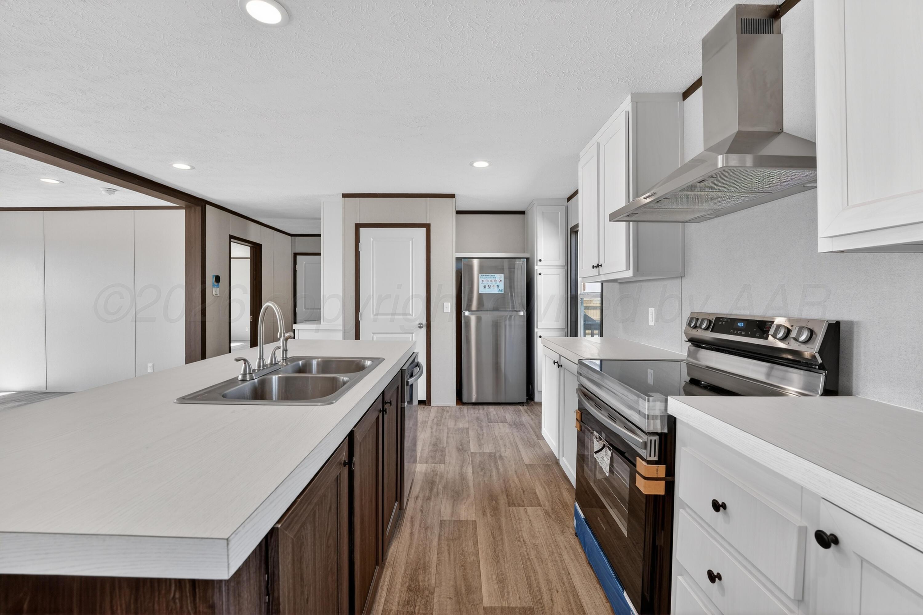 2721 Avery Rd Canyon Canyon, TX 79015 - Photo 9 of 30 a kitchen with stainless steel appliances granite countertop a sink and stove top oven
