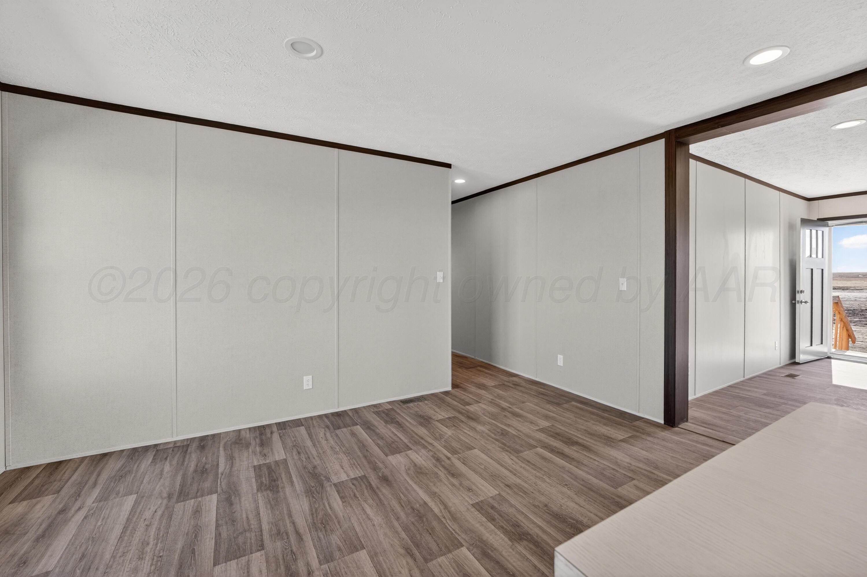 2721 Avery Rd Canyon Canyon, TX 79015 - Photo 10 of 30 a view of an empty room with wooden floor and a window