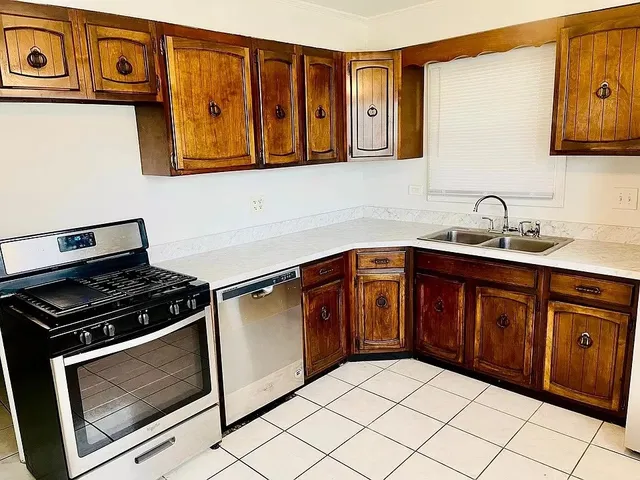 a kitchen with stainless steel appliances granite countertop a stove and a microwave