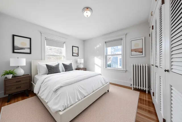 a spacious bedroom with a bed and a window