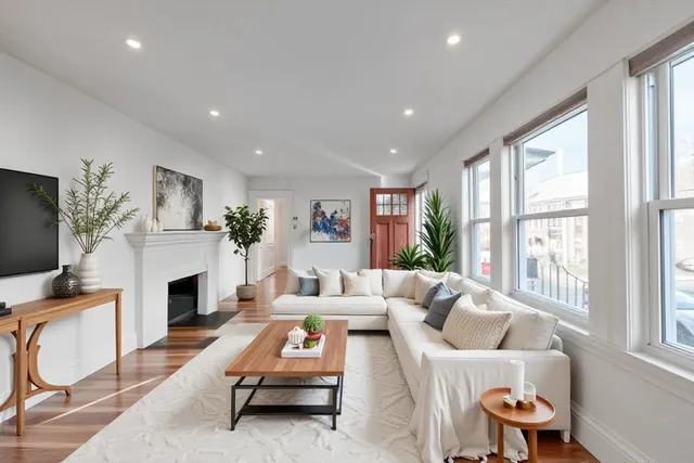 a living room with furniture fireplace and window