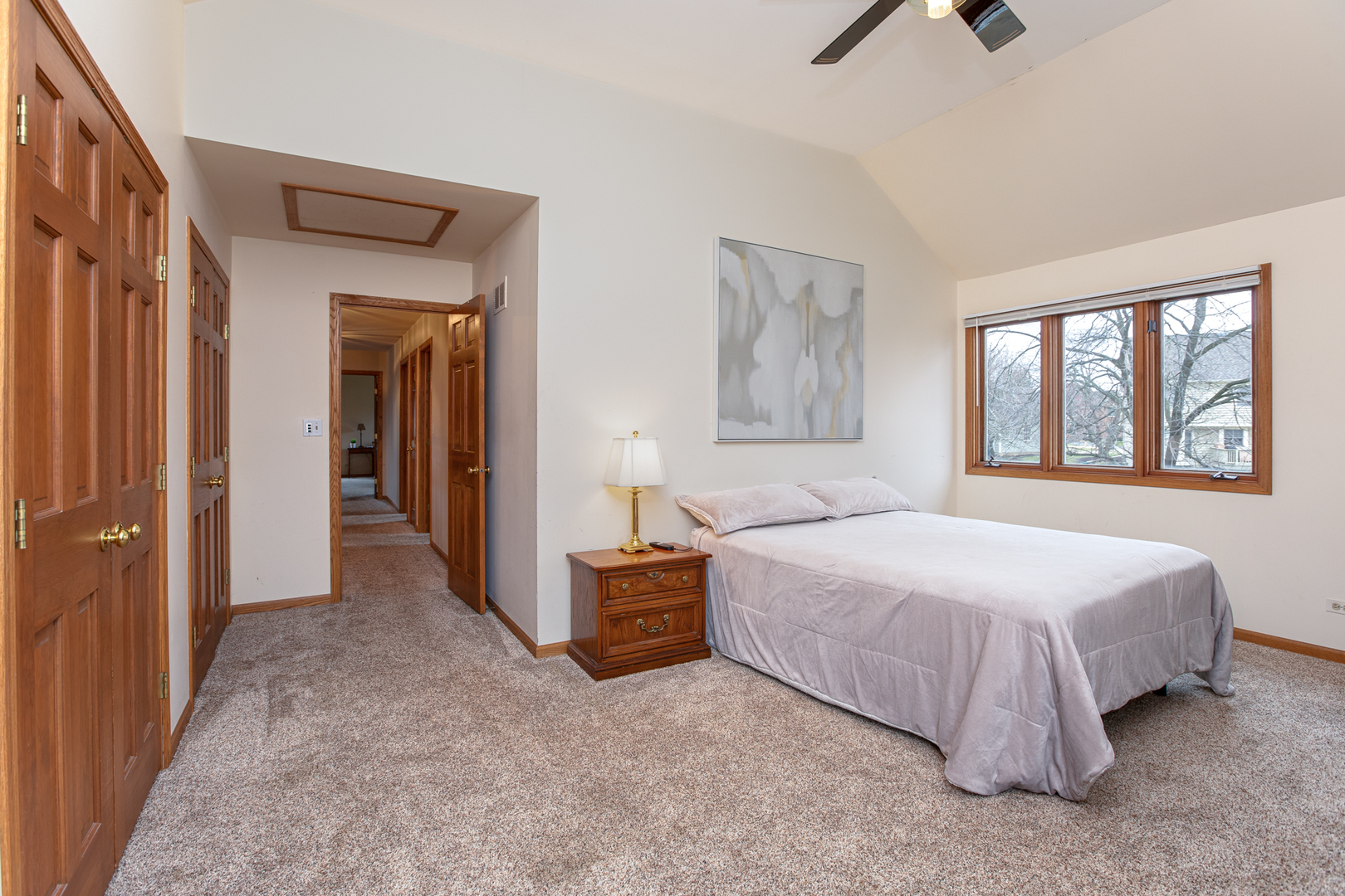 29W220 Oak Knoll Road West Chicago, IL 60185 - Photo 15 of 24 a bedroom with a bed and a chandelier