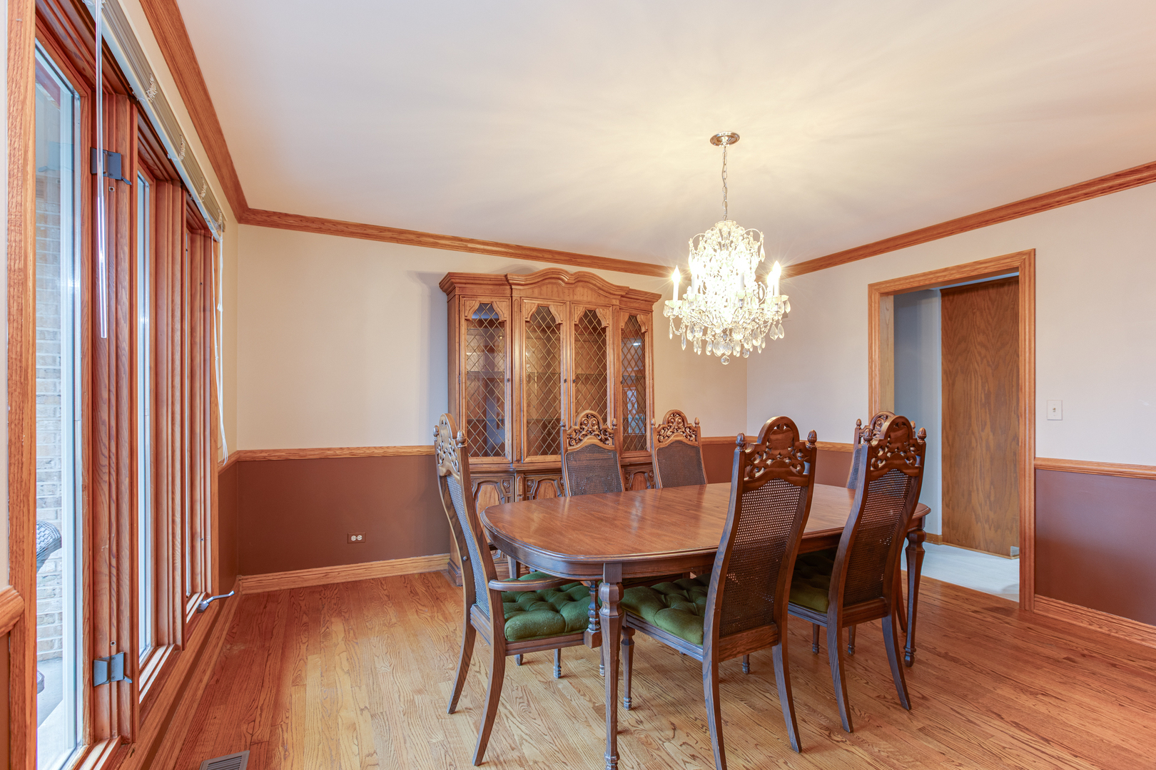29W220 Oak Knoll Road West Chicago, IL 60185 - Photo 7 of 24 a dining room with furniture a chandelier and wooden floor