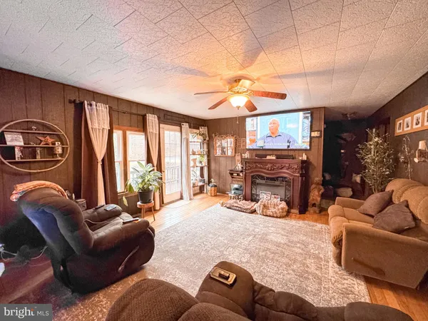 a view of a livingroom with furniture and a flat screen tv